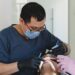 Dentists performing a dental procedure on a patient, representing services covered by Delta Dental of Colorado.