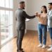 Health insurance for Colorado realtors real estate agent handing keys to new homeowners.